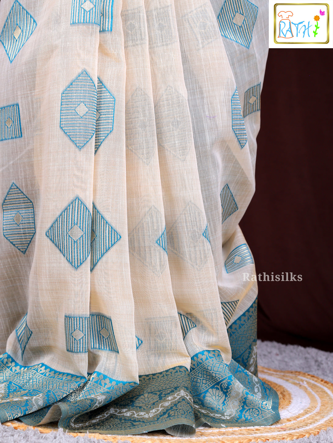 Cream Synthetic Saree with Woven Teal Geometric Design